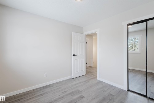 Unfurnished bedroom with light wood-style floors and a closet - 10423 35 Avenue, Edmonton, AB - Indoor Photo Showing Other Room