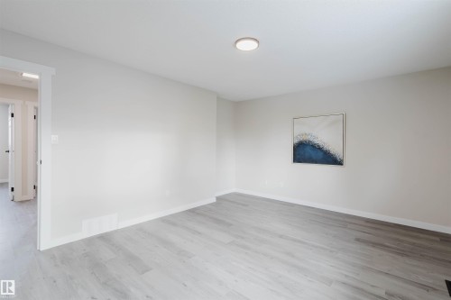 Empty room with light wood-style floors and baseboards - 10423 35 Avenue, Edmonton, AB - Indoor Photo Showing Other Room
