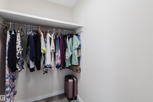 Walk in closet with wood finished floors - 10423 35 Avenue, Edmonton, AB - Indoor With Storage