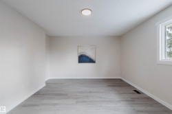 Unfurnished room featuring light wood-type flooring and baseboards - 