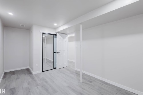 Unfurnished bedroom with light wood finished floors, a closet, and recessed lighting - 10423 35 Avenue, Edmonton, AB - Indoor Photo Showing Other Room
