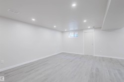 Basement featuring recessed lighting and light wood finished floors - 