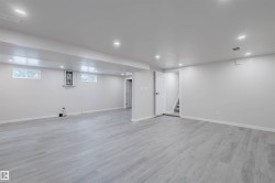 Basement with recessed lighting and light wood-style floors - 