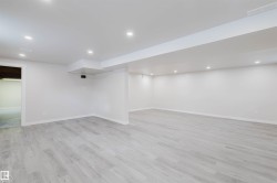 Finished below grade area with recessed lighting and light wood finished floors - 