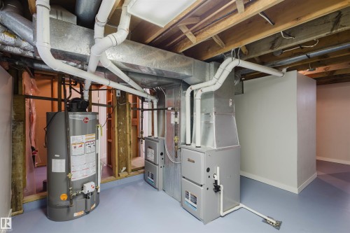 Utility room featuring gas water heater and heating unit - 10423 35 Avenue, Edmonton, AB - Indoor Photo Showing Basement