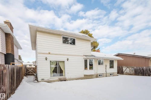 Snow covered property with a gate and a fenced backyard - 10423 35 Avenue, Edmonton, AB - Outdoor With Exterior