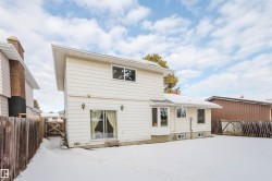 Snow covered property with a gate and a fenced backyard - 