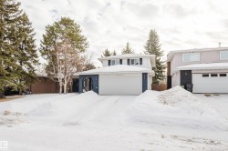 Traditional home featuring a garage and brick siding - 