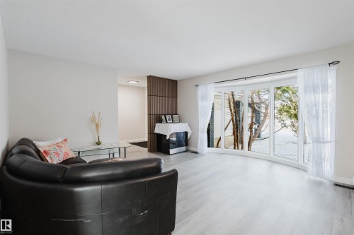 Living area featuring wood finished floors and baseboards - 10423 35 Avenue, Edmonton, AB - Indoor