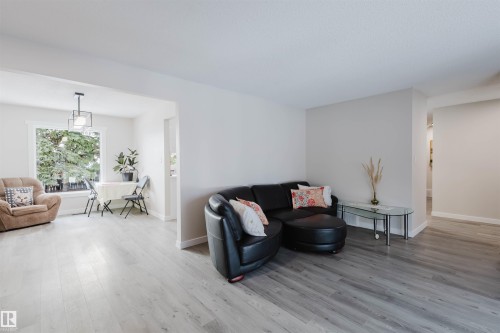 Living area featuring wood finished floors - 10423 35 Avenue, Edmonton, AB - Indoor Photo Showing Living Room