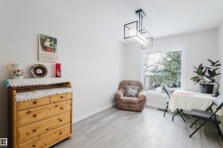 Sitting room with light wood-style flooring and baseboards - 