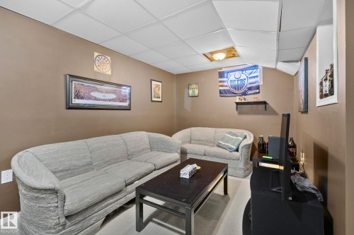 Living area featuring a paneled ceiling and carpet flooring - 3 1820 56 Street, Edmonton, AB - Indoor
