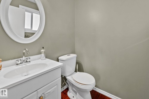 Half bath featuring vanity and dark wood-style floors - 3 1820 56 Street, Edmonton, AB - Indoor Photo Showing Bathroom
