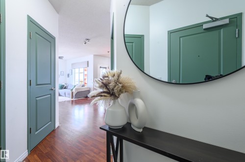 Hallway featuring dark wood-type flooring - 411 1619 James Mowatt Trail, Edmonton, AB - Indoor Photo Showing Other Room