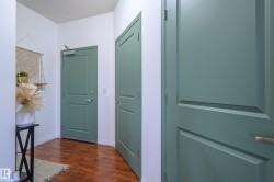 Hallway featuring dark wood-style flooring and a textured ceiling - 