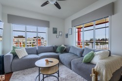 Living room featuring ceiling fan and wood finished floors - 