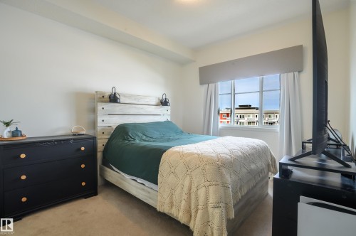 View of carpeted bedroom - 411 1619 James Mowatt Trail, Edmonton, AB - Indoor Photo Showing Bedroom