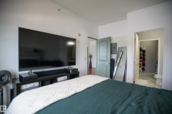 Bedroom with ensuite bathroom, a closet, and electric panel - 