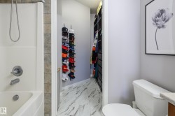 Full bathroom with vanity, shower / tub combination, light marble finish flooring, a textured ceiling, and a walk in closet - 