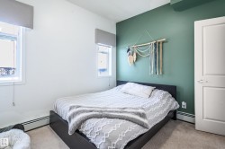 Bedroom featuring carpet floors and a baseboard heating unit - 