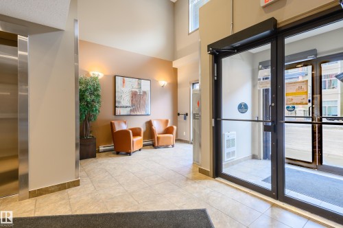 Community lobby with a high ceiling - 411 1619 James Mowatt Trail, Edmonton, AB - Indoor Photo Showing Other Room