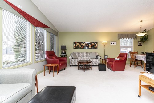 Living area with carpet flooring and a textured ceiling - 2112 67 Street Nw, Edmonton, AB - Indoor Photo Showing Living Room