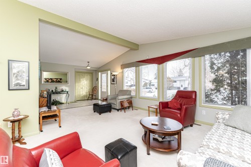 Living area with light colored carpet and beamed ceiling - 2112 67 Street Nw, Edmonton, AB - Indoor Photo Showing Living Room