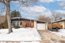 View of front of home featuring brick siding, a garage, and driveway - 2112 67 Street Nw, Edmonton, AB  - Outdoor 
