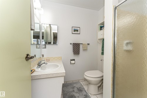 Bathroom with vanity, a shower stall, light tile patterned floors, and crown molding - 2112 67 Street Nw, Edmonton, AB - Indoor Photo Showing Bathroom