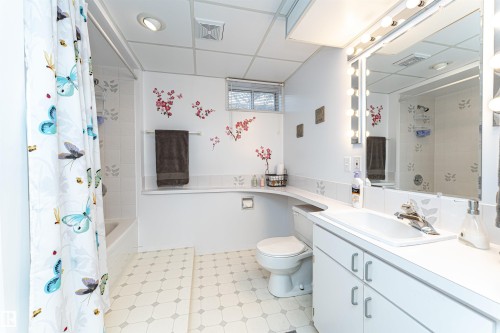 Bathroom featuring a paneled ceiling, shower / bath combo, and vanity - 2112 67 Street Nw, Edmonton, AB - Indoor Photo Showing Bathroom