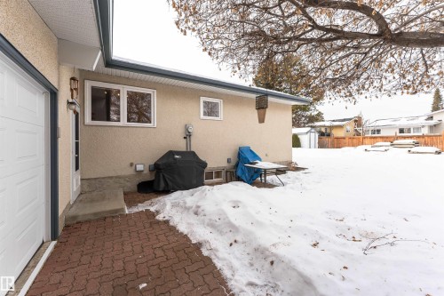 View of snow covered exterior with a patio area and stucco siding - 2112 67 Street Nw, Edmonton, AB - Outdoor With Exterior