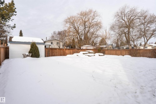 Yard layered in snow featuring a fenced backyard and an outdoor structure - 2112 67 Street Nw, Edmonton, AB - Outdoor