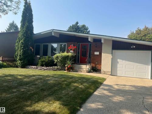 Single story home with driveway, a front lawn, brick siding, and an attached garage - 2112 67 Street Nw, Edmonton, AB - Outdoor