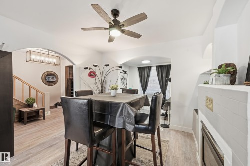 Dining space featuring arched walkways, light wood finished floors, and ceiling fan - 10656 93 Street, Edmonton, AB - Indoor Photo Showing Dining Room