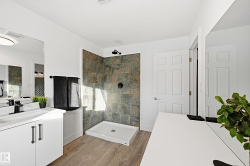 Full bath featuring vanity, a stall shower, and light wood-style flooring - 10656 93 Street, Edmonton, AB - Indoor Photo Showing Bathroom