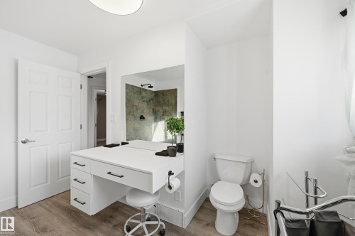 Bathroom with a tile shower, light wood-style flooring, and vanity - 10656 93 Street, Edmonton, AB - Indoor Photo Showing Bathroom