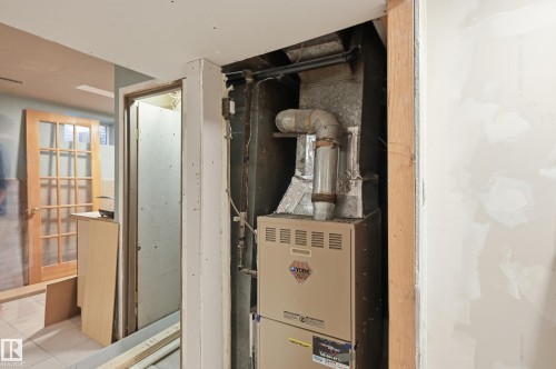 Utility room featuring heating unit - 10656 93 Street, Edmonton, AB - Indoor Photo Showing Basement