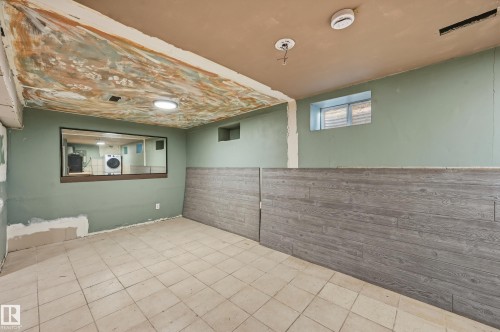 Below grade area with washer / clothes dryer - 10656 93 Street, Edmonton, AB - Indoor Photo Showing Other Room