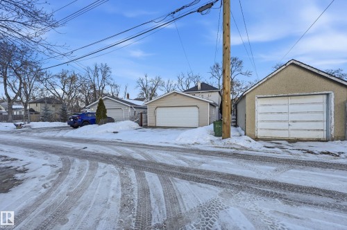 View of front of property with stucco siding, a residential view, and an outdoor structure - 10656 93 Street, Edmonton, AB - Outdoor