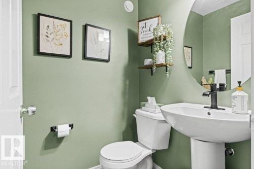 Bathroom with toilet and baseboards - 3351 Orchards Link, Edmonton, AB - Indoor Photo Showing Bathroom