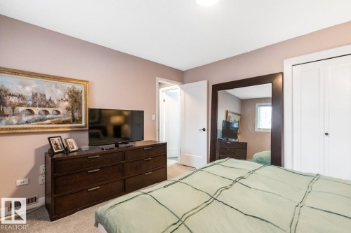 Bedroom featuring light carpet and a closet - 6411 180 Street, Edmonton, AB - Indoor Photo Showing Bedroom