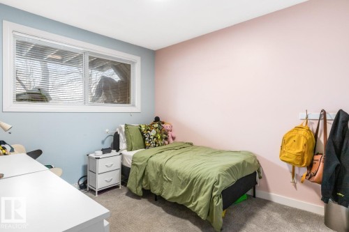 Bedroom featuring baseboards and light carpet - 6411 180 Street, Edmonton, AB - Indoor Photo Showing Bedroom