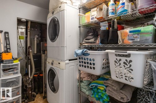 Laundry room with stacked washer and clothes dryer - 6411 180 Street, Edmonton, AB - Indoor Photo Showing Laundry Room