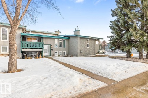 Snow covered back of property featuring a balcony and a chimney - 6411 180 Street, Edmonton, AB - Outdoor