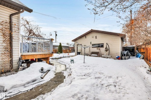 Yard covered in snow with a wooden deck - 11432 71 Street, Edmonton, AB - Outdoor