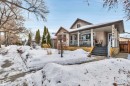 View of front of home featuring covered porch and stone siding - 11432 71 Street, Edmonton, AB  - Outdoor With Deck Patio Veranda 
