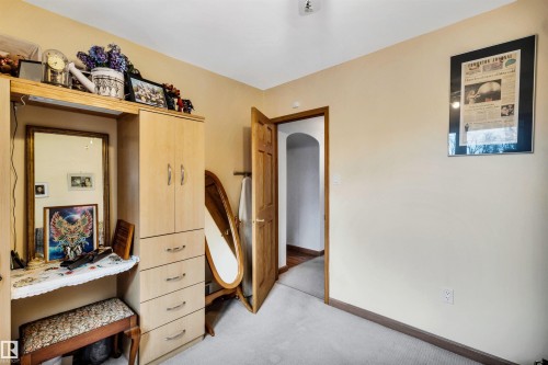 Carpeted bedroom with baseboards and arched walkways - 11432 71 Street, Edmonton, AB - Indoor Photo Showing Other Room