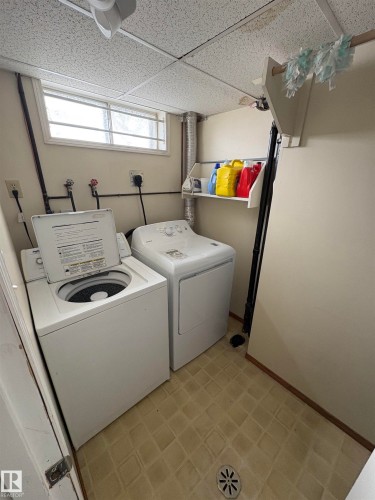 Laundry room featuring a paneled ceiling, light flooring, and independent washer and dryer - Edmonton, AB - Indoor Photo Showing Laundry Room