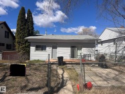 Rear exterior featuring light grey siding and a composite wood deck - 