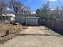 Detached garage with horizontal siding and an overhead door - 